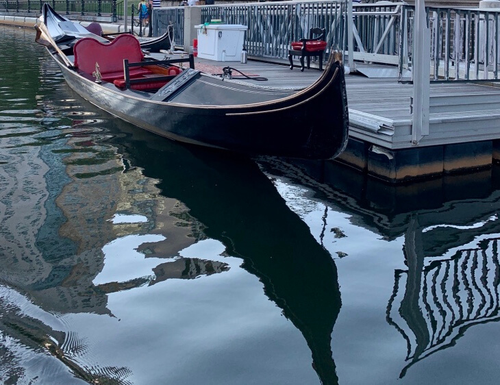 A single gondola tied up to a dock