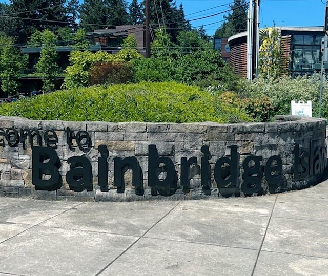 Welcome to Bainbridge Island sign on low stone wall