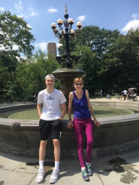 Man and woman leaning against Bethesda Fountain in Central Park NYC